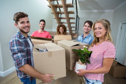 Friendly moving team unloading items in Bromley