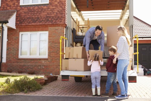 Front view of a Bromley man with van parked outside a home, team preparing to load boxes